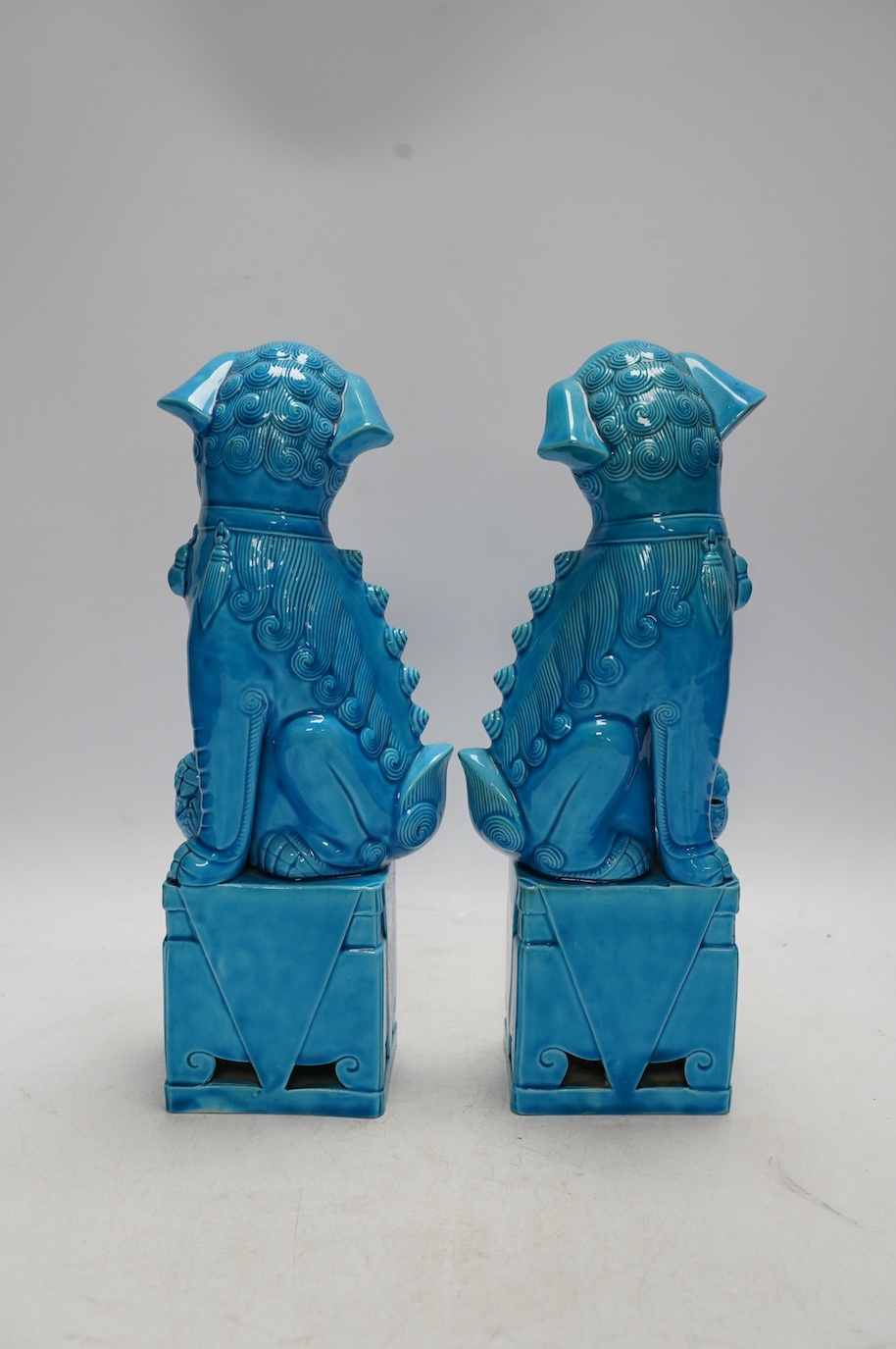 A pair of Chinese turquoise glazed lion dogs, 29cm. Condition - good